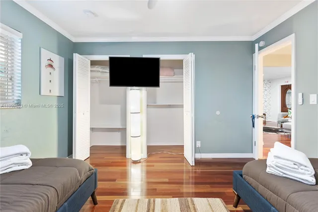a spacious bedroom with a bed and a view of living room