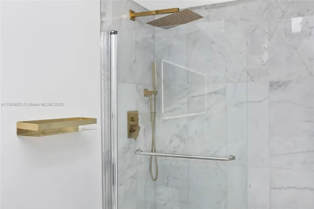 a view of a house with brick walls and a yard with plants