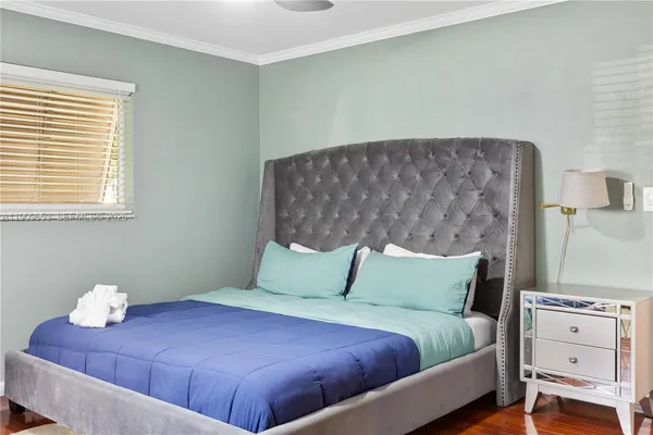 a bedroom with a bed and a table