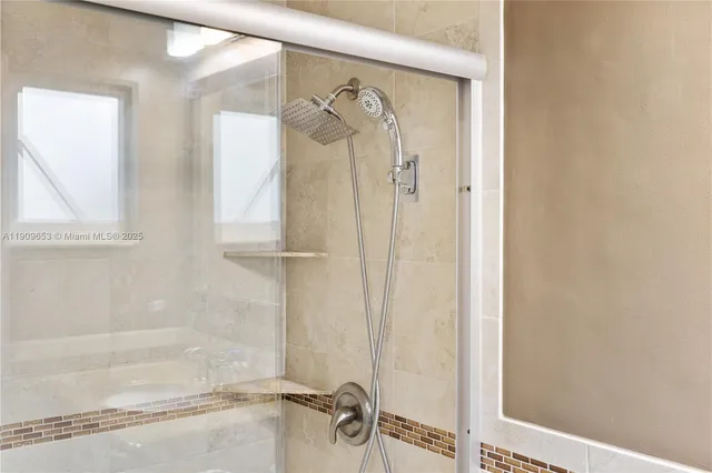 a bathroom with a glass shower door