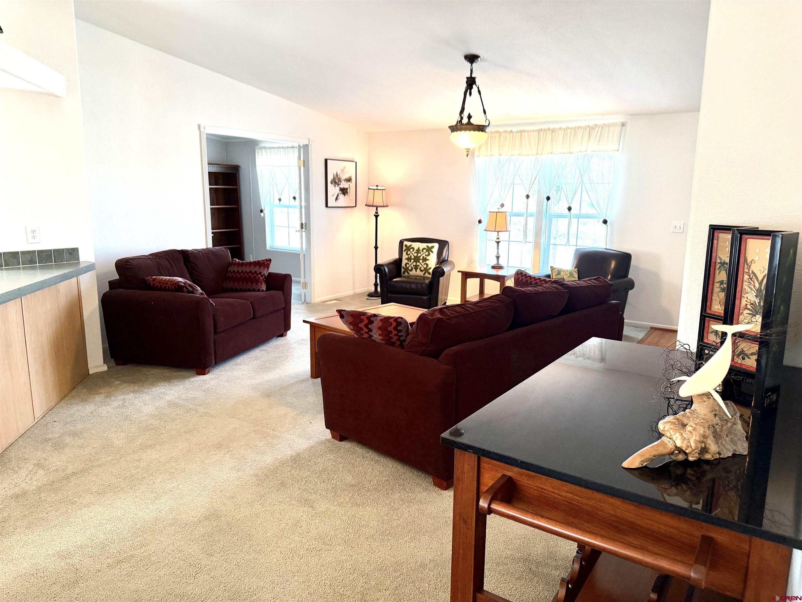 901 6530 Road, Unit 1101 Montrose, CO 81401 - Photo 13 of 45 a living room with furniture and a flat screen tv