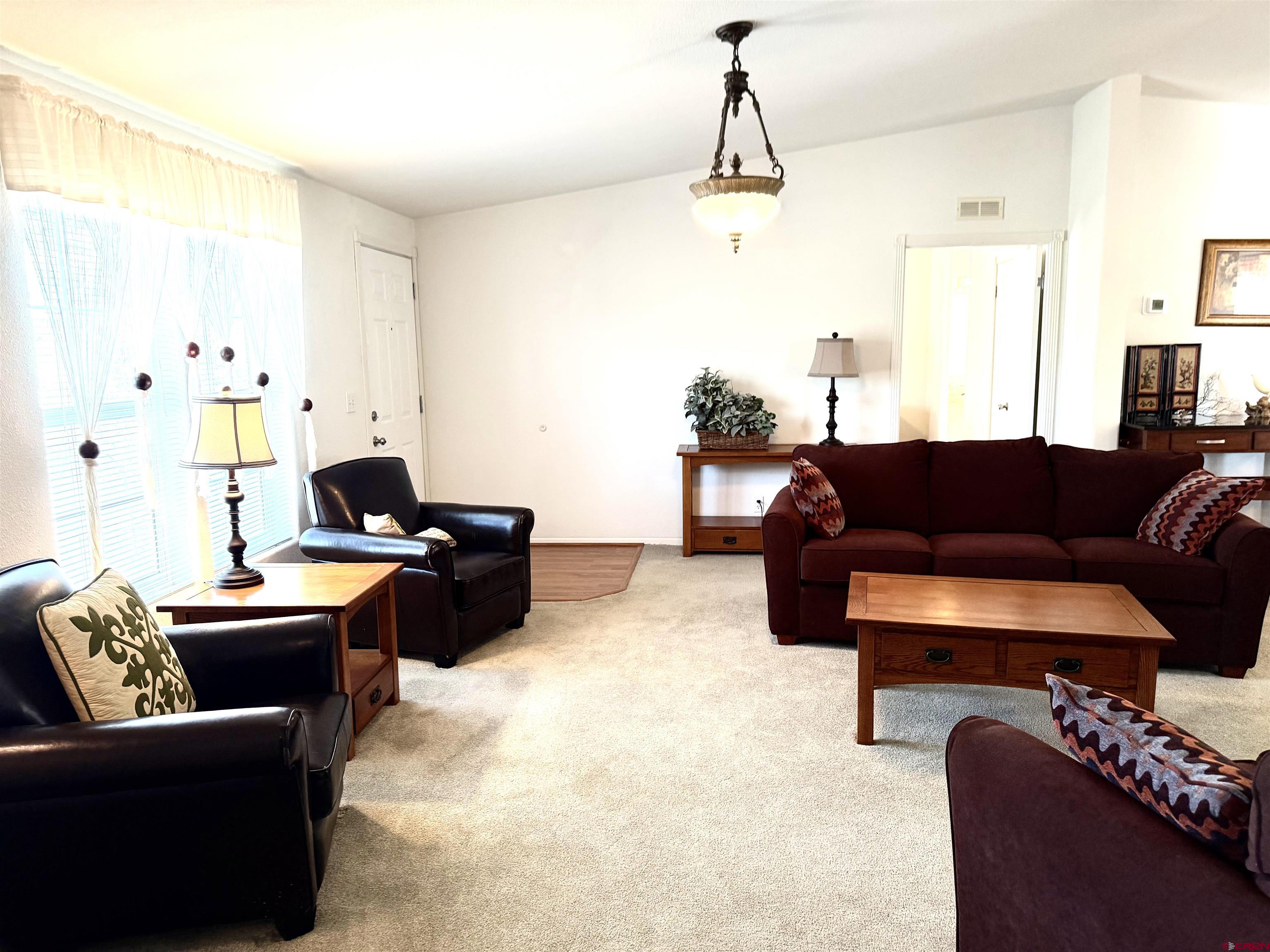 901 6530 Road, Unit 1101 Montrose, CO 81401 - Photo 14 of 45 a living room with furniture and wooden floor