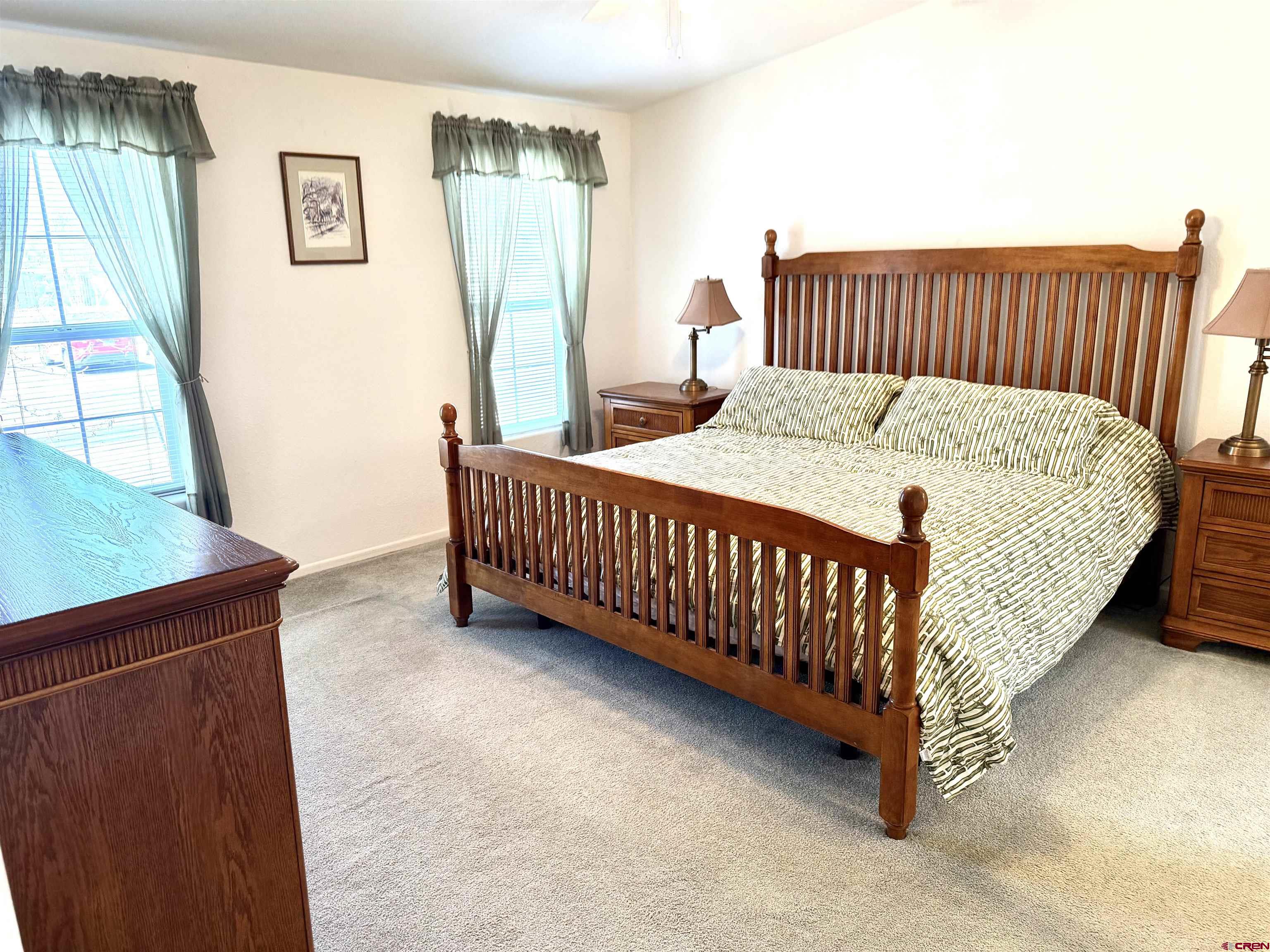 901 6530 Road, Unit 1101 Montrose, CO 81401 - Photo 17 of 45 a bed sitting in a bedroom next to a window
