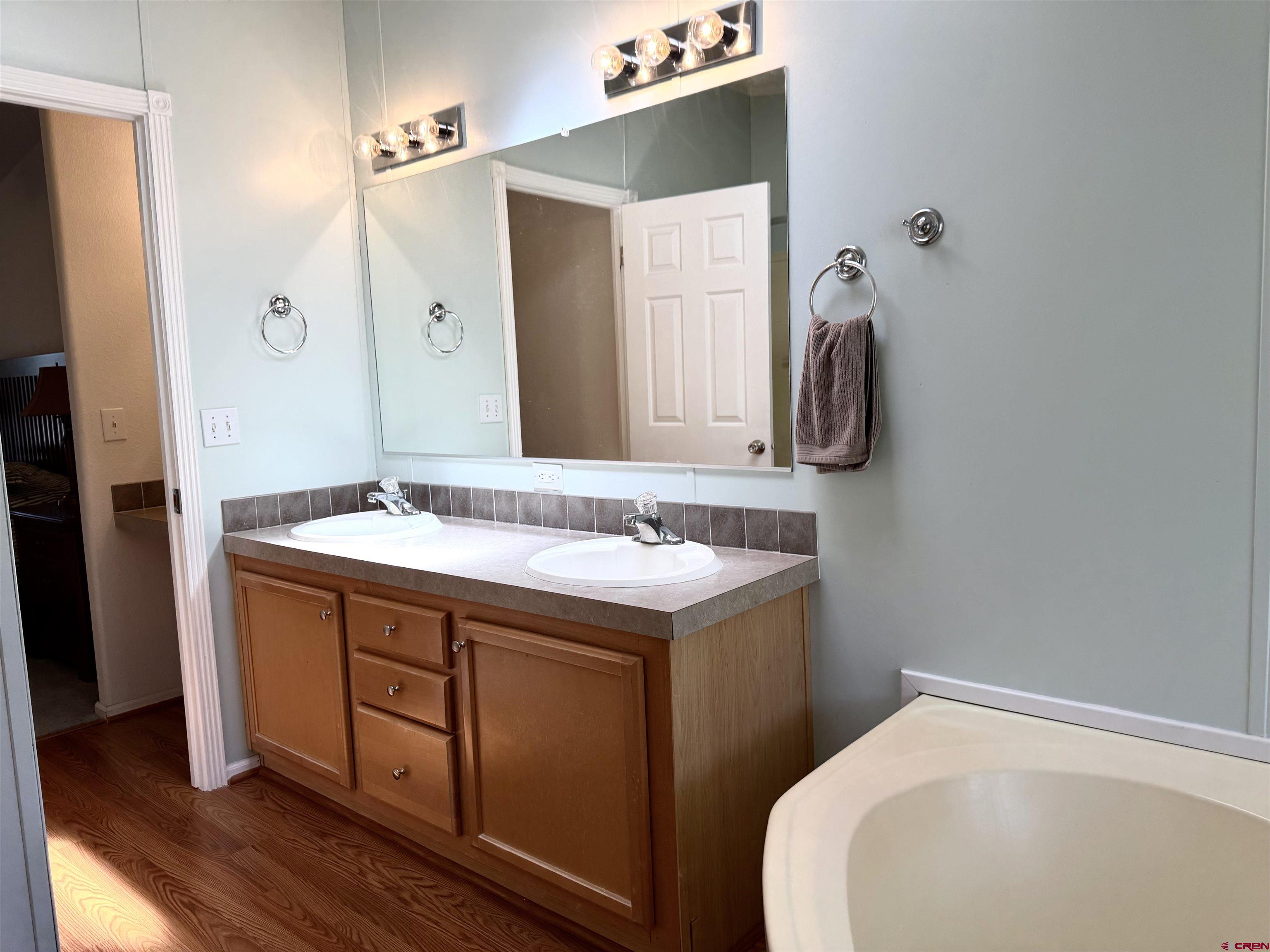 901 6530 Road, Unit 1101 Montrose, CO 81401 - Photo 20 of 45 a bathroom with a sink and a mirror