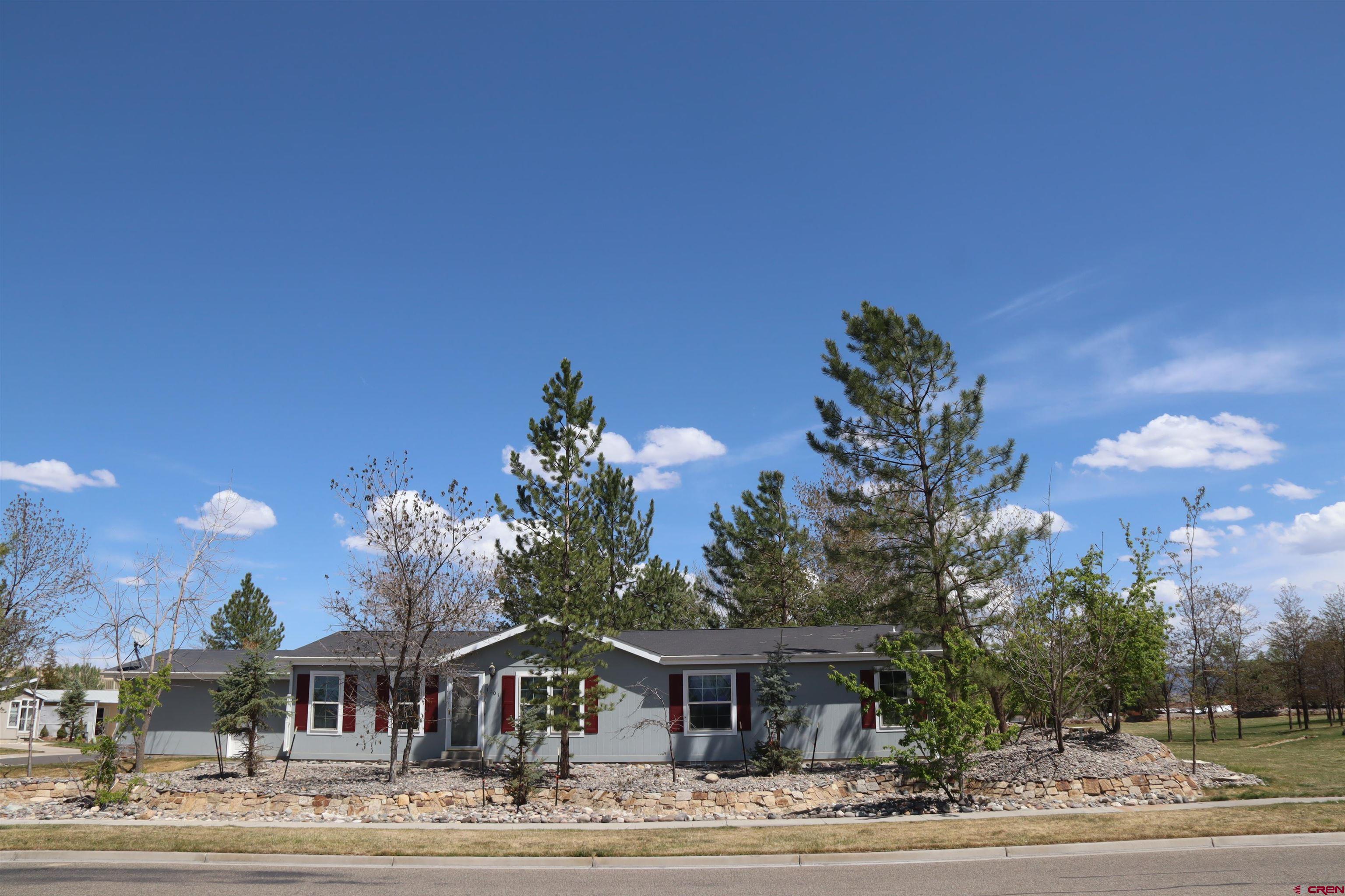 901 6530 Road, Unit 1101 Montrose, CO 81401 - Photo 2 of 45 a front view of a house with a yard