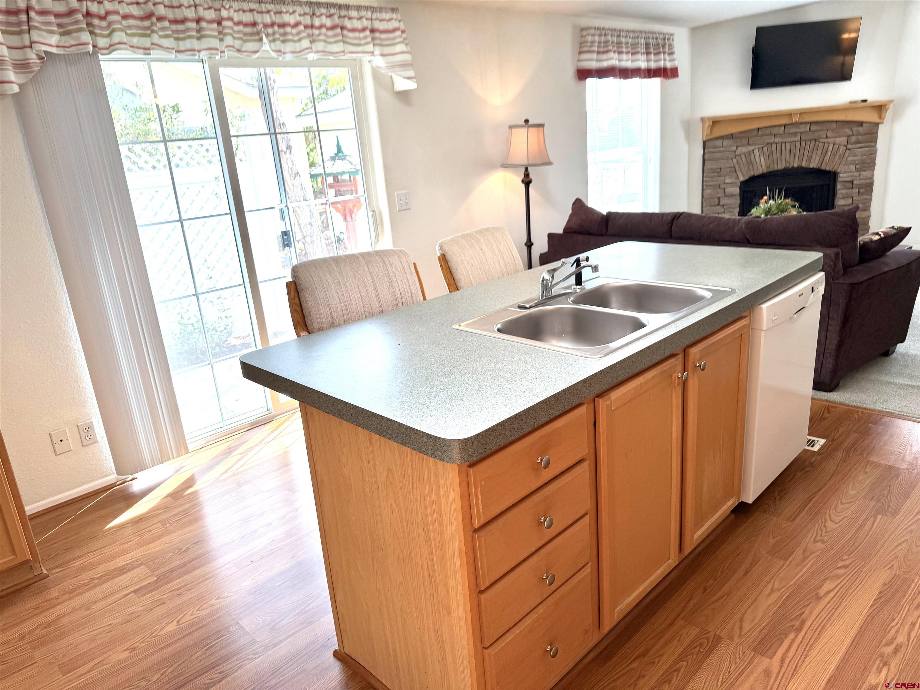 901 6530 Road, Unit 1101 Montrose, CO 81401 - Photo 27 of 45 a kitchen with stainless steel appliances granite countertop a sink a stove and wooden floors