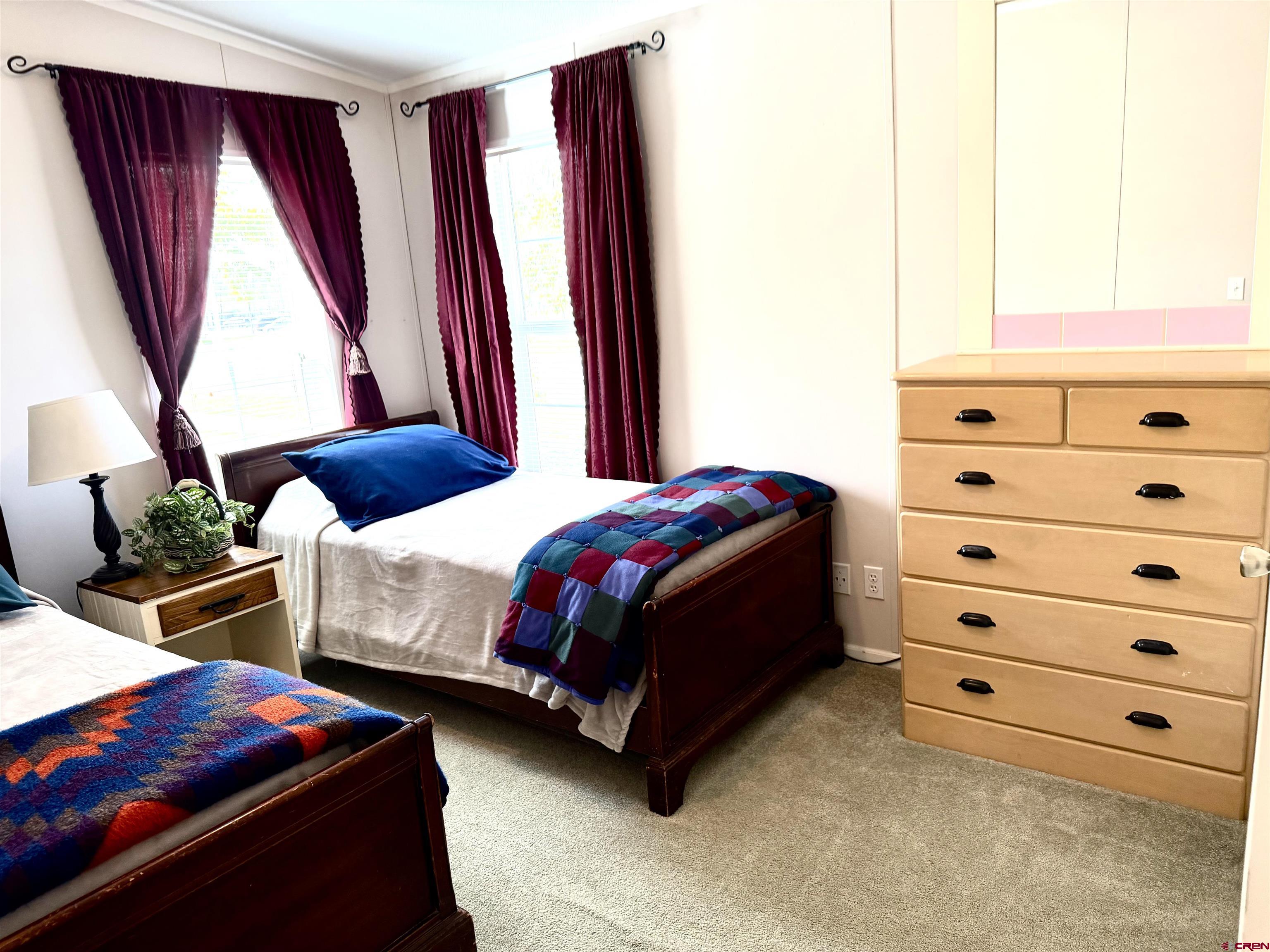 901 6530 Road, Unit 1101 Montrose, CO 81401 - Photo 33 of 45 a bedroom with a bed and a dresser