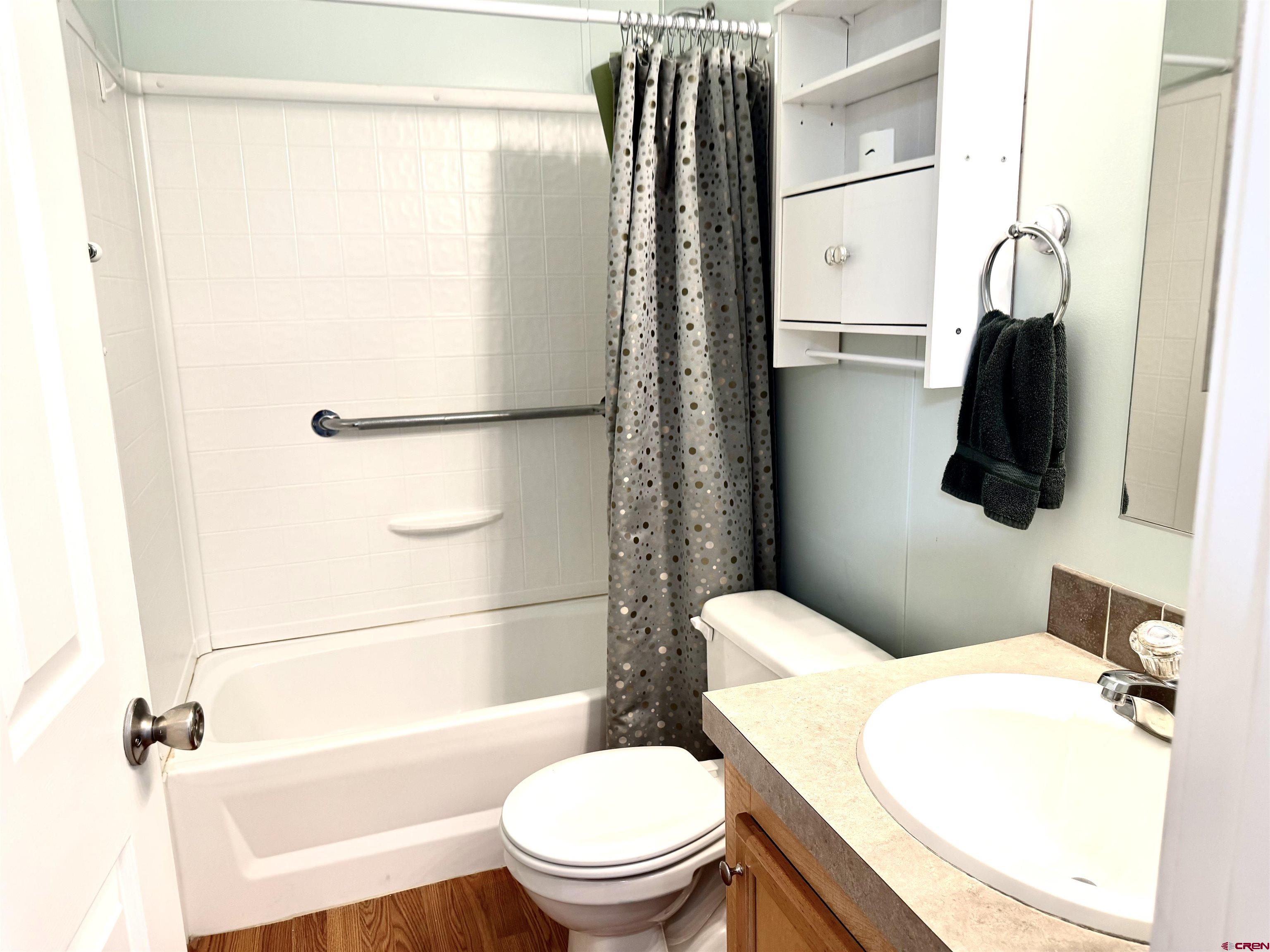 901 6530 Road, Unit 1101 Montrose, CO 81401 - Photo 35 of 45 a white toilet sitting next to a bathroom sink