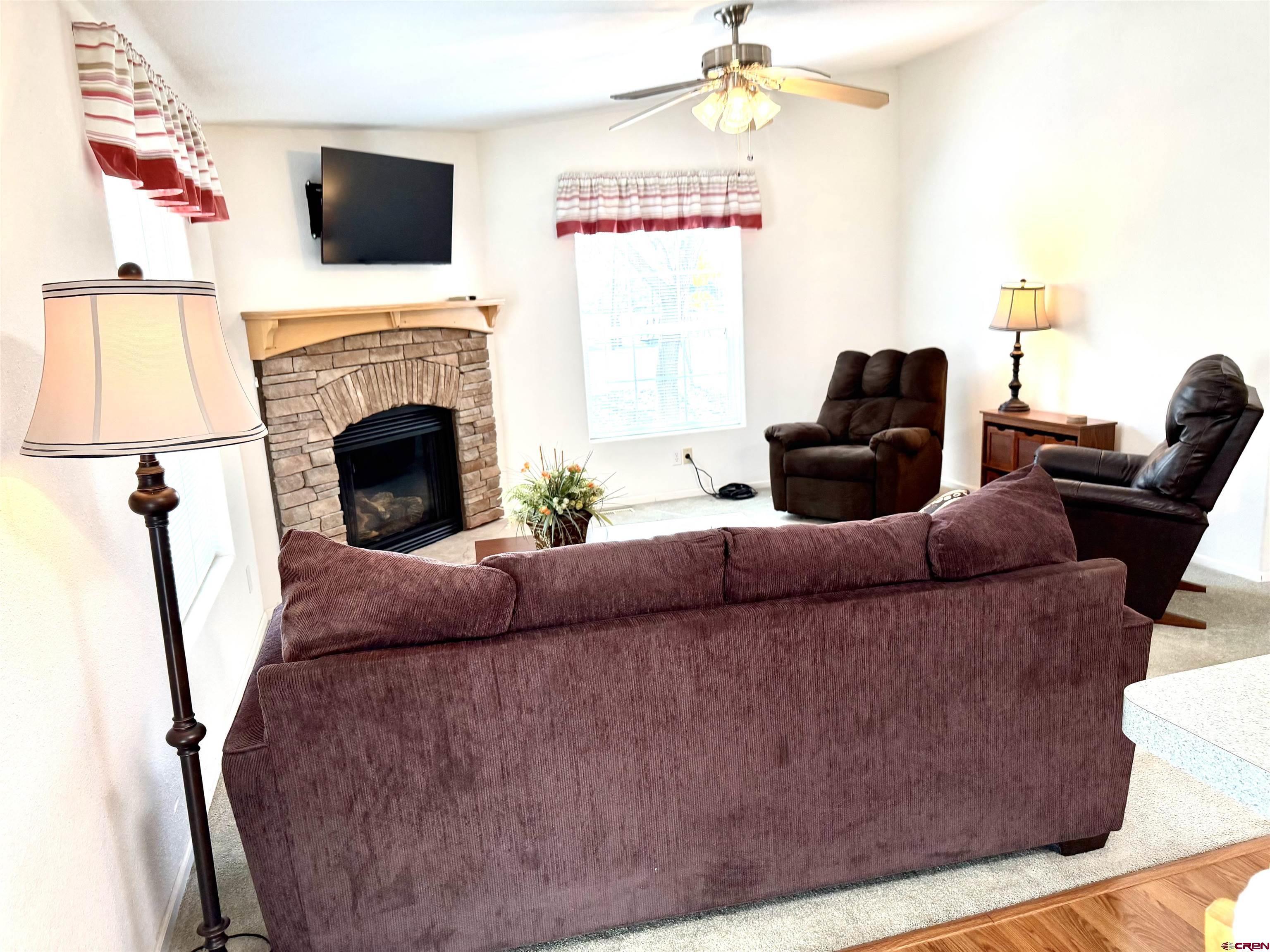 901 6530 Road, Unit 1101 Montrose, CO 81401 - Photo 36 of 45 a living room with furniture and a fireplace