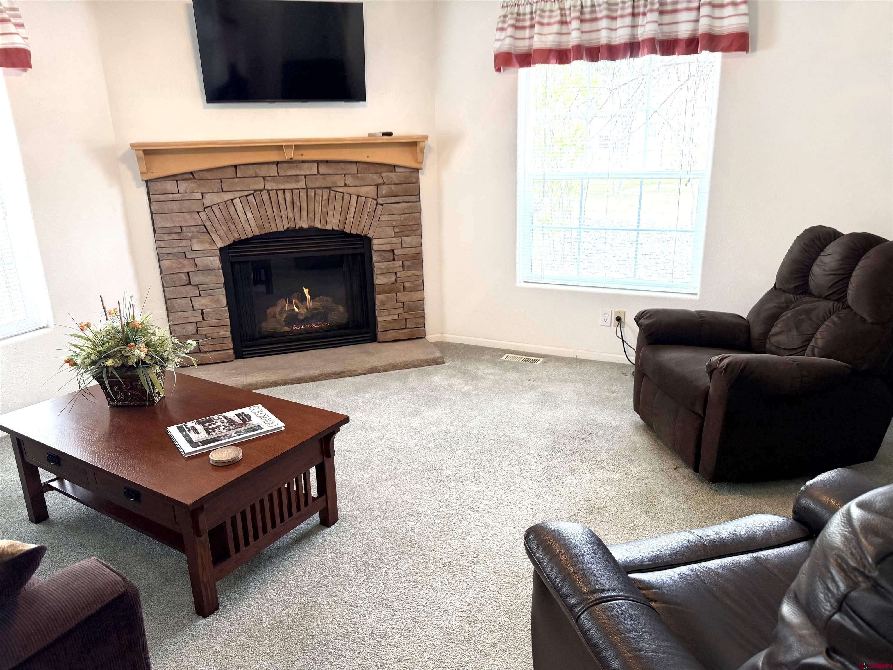 901 6530 Road, Unit 1101 Montrose, CO 81401 - Photo 39 of 45 a living room with furniture and a fireplace