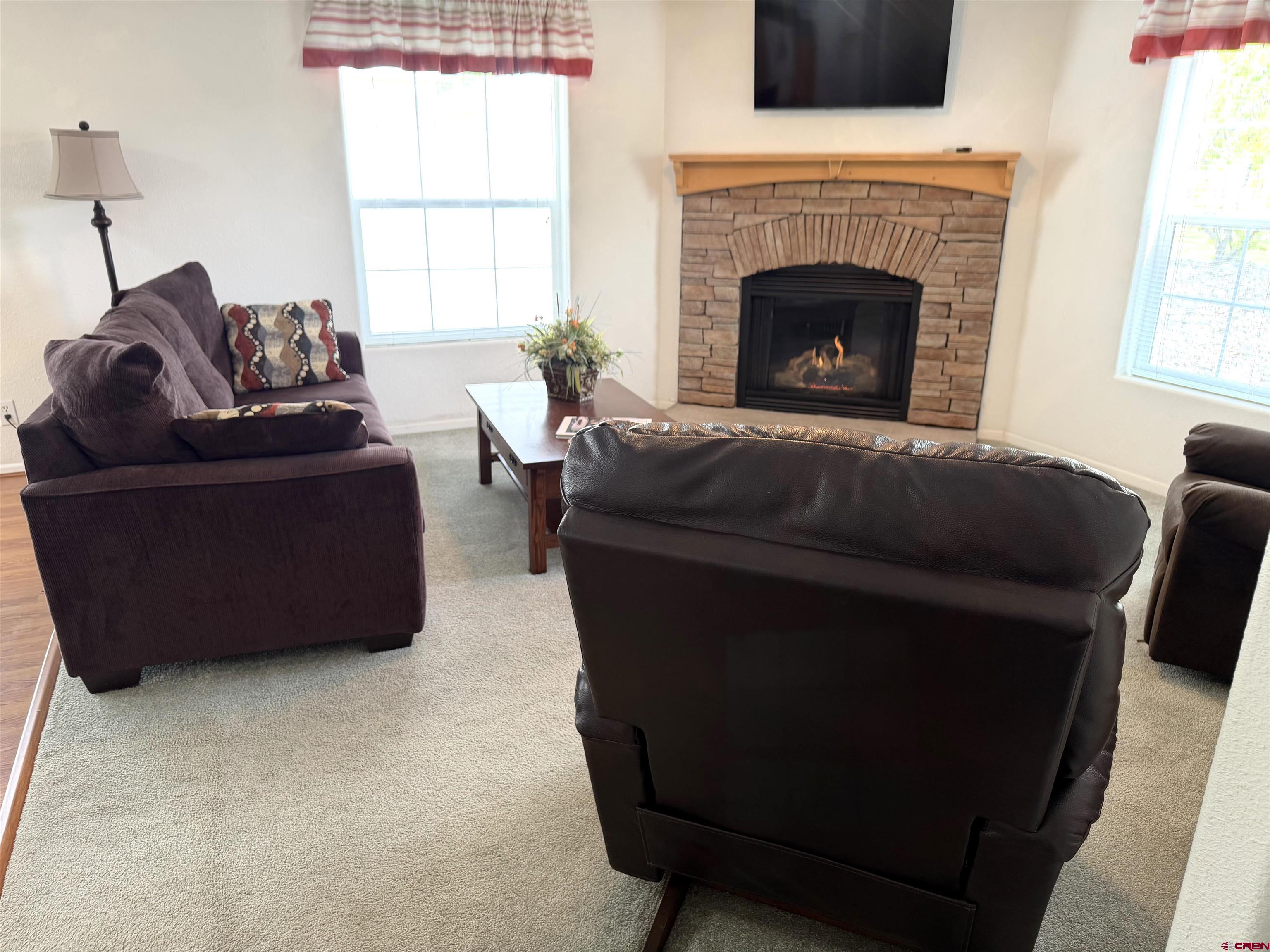 901 6530 Road, Unit 1101 Montrose, CO 81401 - Photo 40 of 45 a living room with furniture and a fireplace