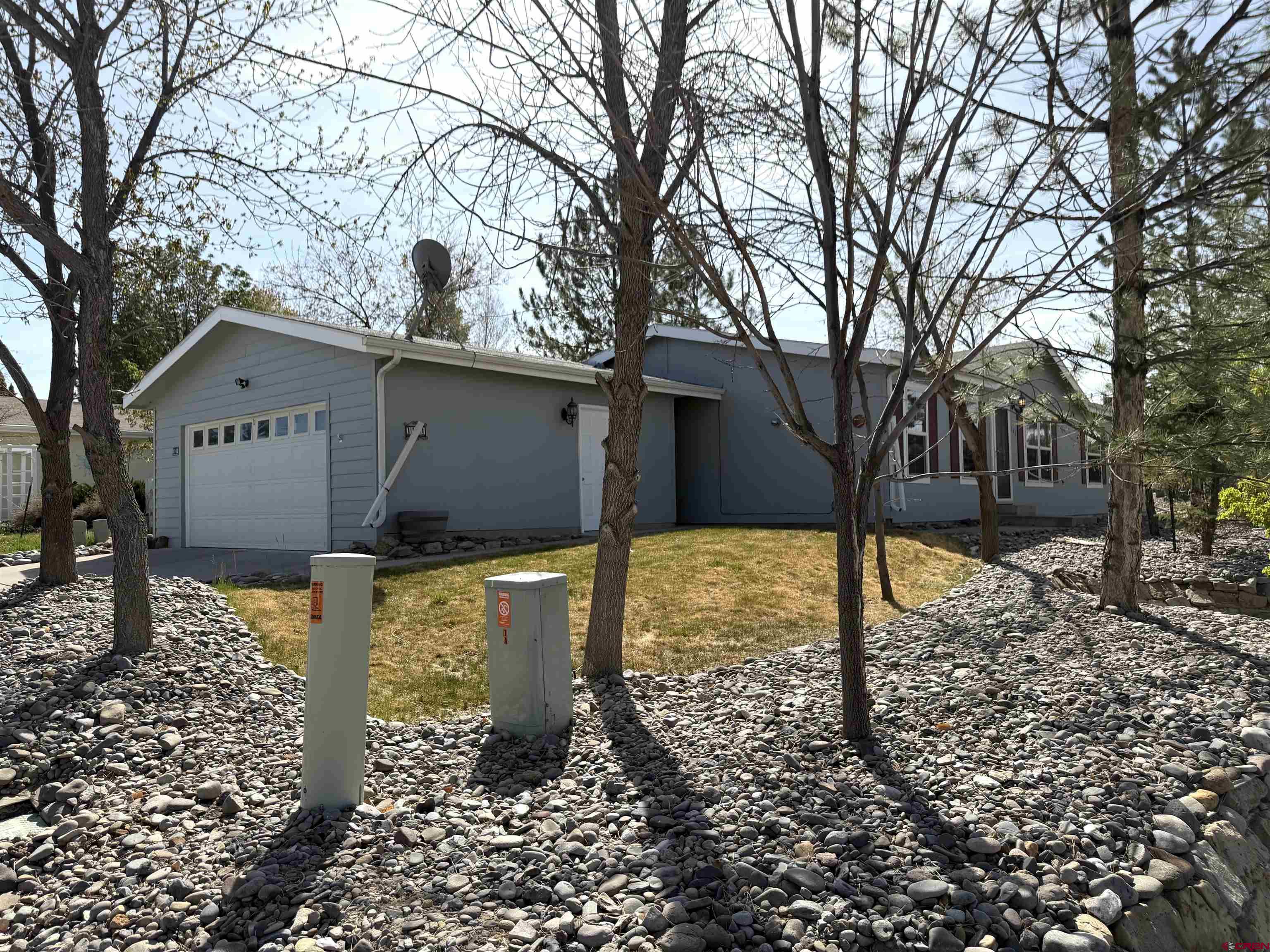 901 6530 Road, Unit 1101 Montrose, CO 81401 - Photo 5 of 45 a front view of a house with a yard