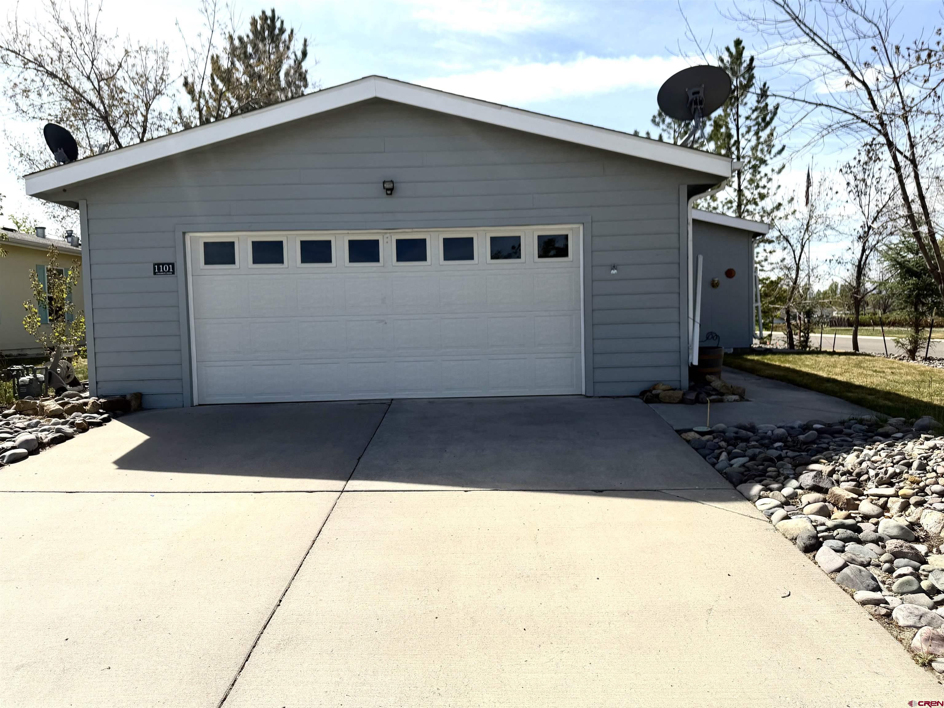 901 6530 Road, Unit 1101 Montrose, CO 81401 - Photo 6 of 45 a front view of a house with a yard