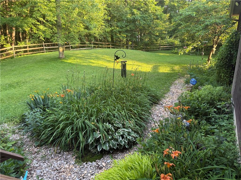 209 Modoc Trail Mercer, PA 16137 - Photo 14 of 17 a swimming pool with lots of green space and trees in the background