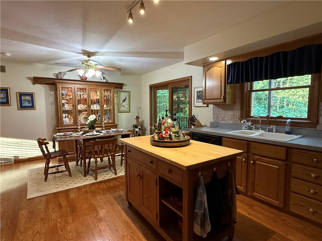 209 Modoc Trail Mercer, PA 16137 - Photo 5 of 17 a kitchen with a stove a sink a dining table and chairs