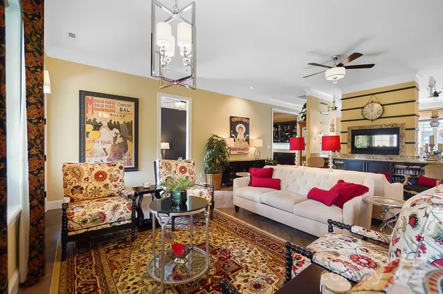 a living room with lots of furniture and a chandelier
