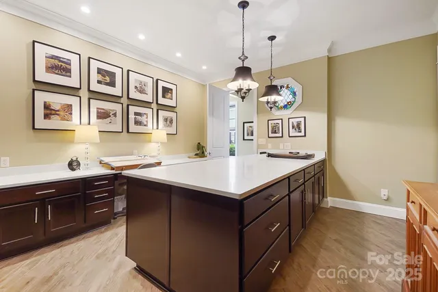 a kitchen that has a center island and some stove in it