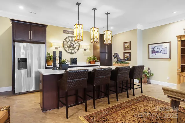 a dining hall with stainless steel appliances granite countertop a dining table and chairs with wooden floor