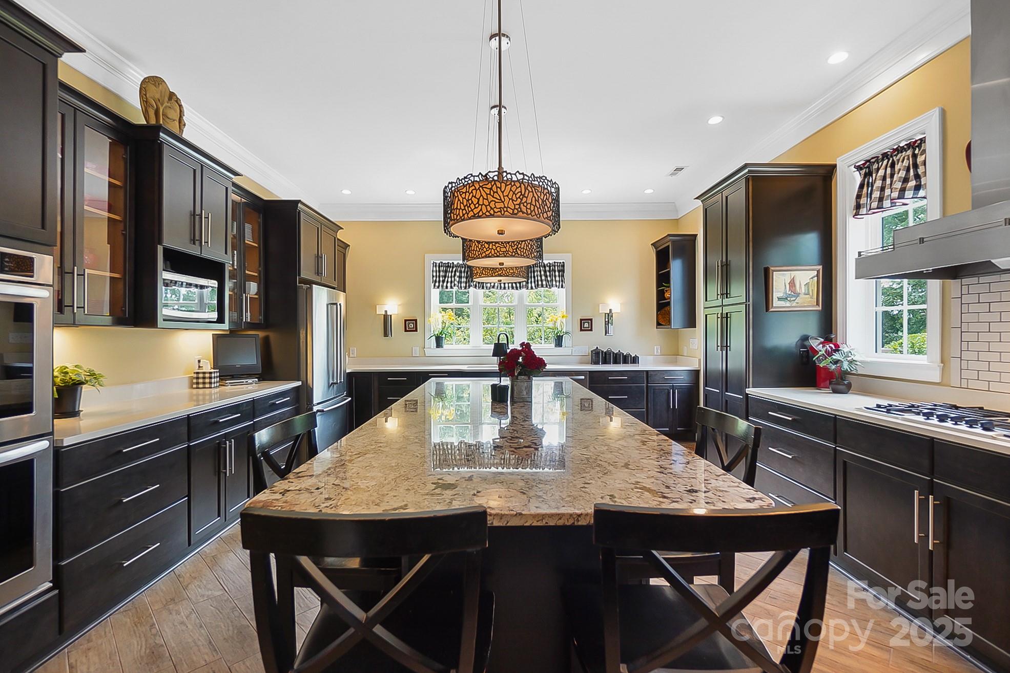 2354 Valelake Road York, SC 29745 - Photo 6 of 48 a kitchen with stainless steel appliances granite countertop a dining table chairs and granite counter tops