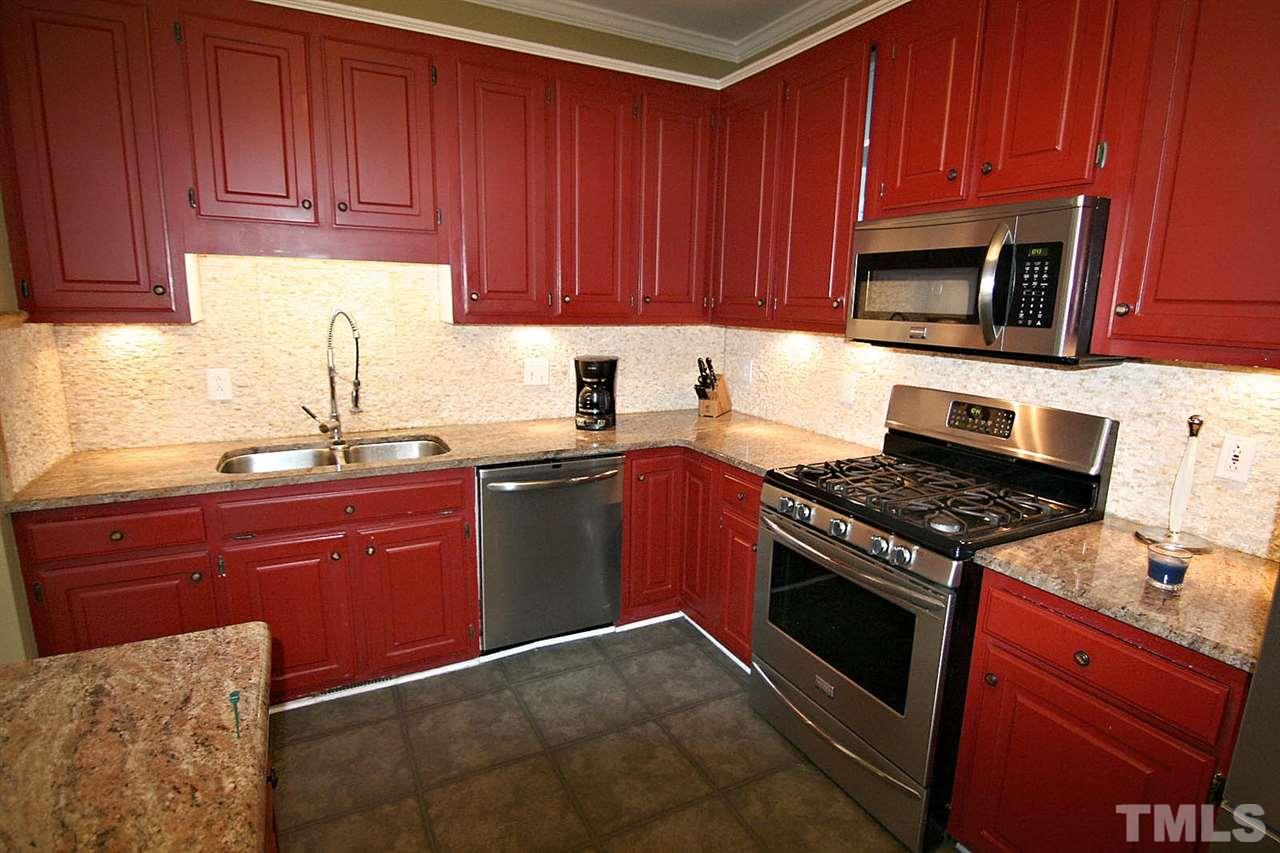 7608 Percy Court Raleigh, NC 27613 - Photo 11 of 25 Kitchen has Plentiful Cabinets, Handsome Granite Countertops and Stunning Tile Backsplash, Under-cabinet Lighting plus Stainless Steel Appliances