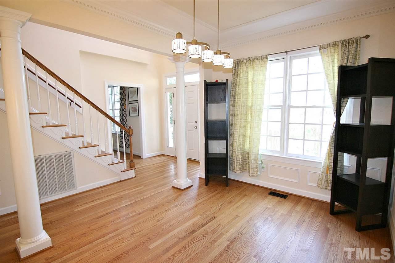 7608 Percy Court Raleigh, NC 27613 - Photo 8 of 25 Dining Room has Tons of Charm -- Dramatic Columns, 9' Smooth Ceilings and Hardwood Floors -- Only the Finest for your Dinner Guests