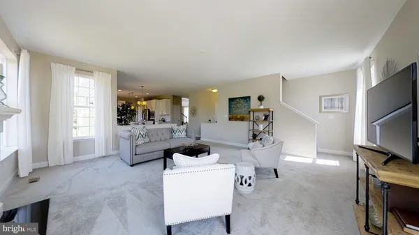 a living room with furniture a large window and a flat screen tv