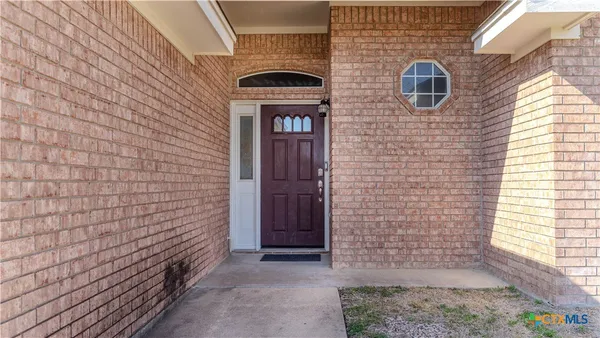 a view of a brick house with an entryway door