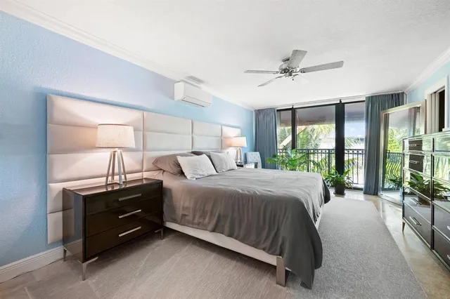 a bedroom with a bed and a large window