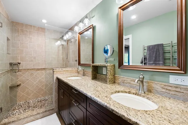 a bathroom with double vanity sink and a mirror