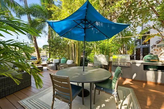 a view of backyard of house with seating space