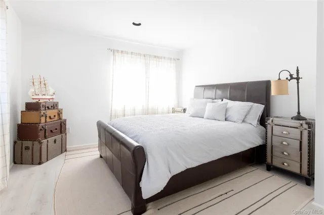 a bedroom with a bed and a tv