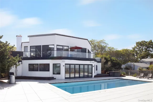 a front view of a building with cars parked