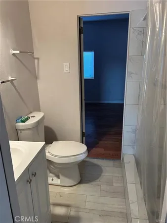 a bathroom with a toilet and a shower