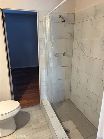 a bathroom with a toilet and shower