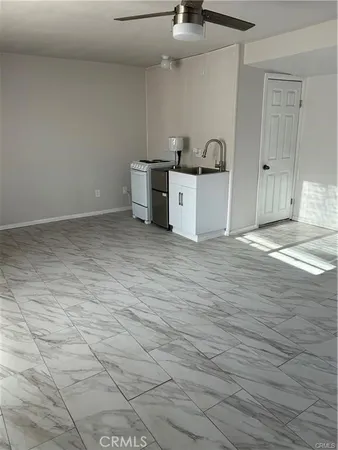 a view of a kitchen with a sink and cabinets