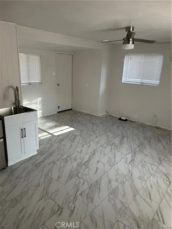 a view of a kitchen with a sink dishwasher a refrigerator and cabinets