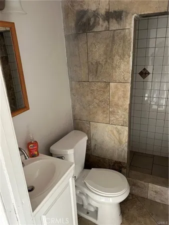 a bathroom with a toilet and a shower