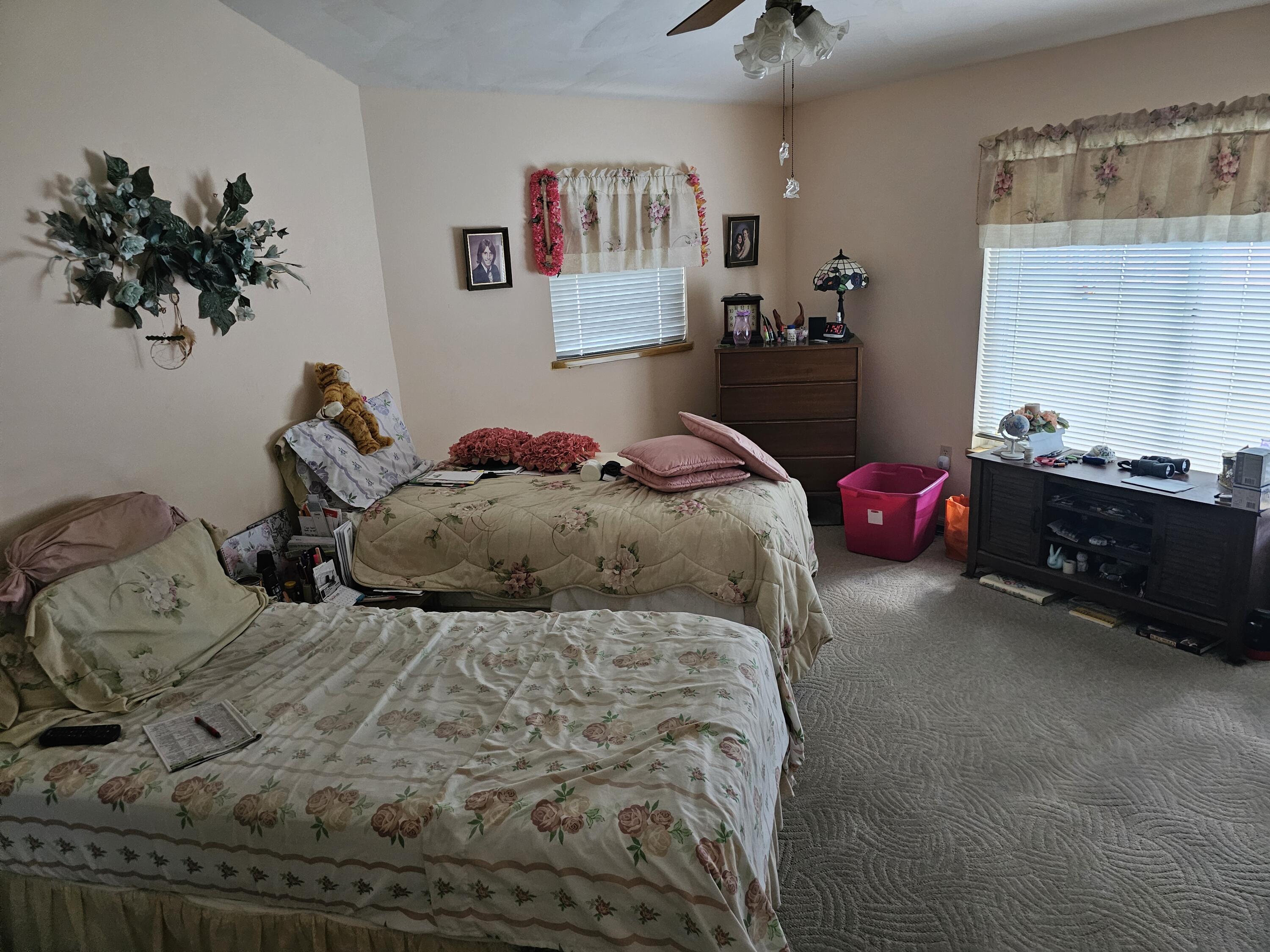 13578 Southwest 144th Parkway Okeechobee, FL 34974 - Photo 15 of 21 a bedroom with a bed and a chandelier