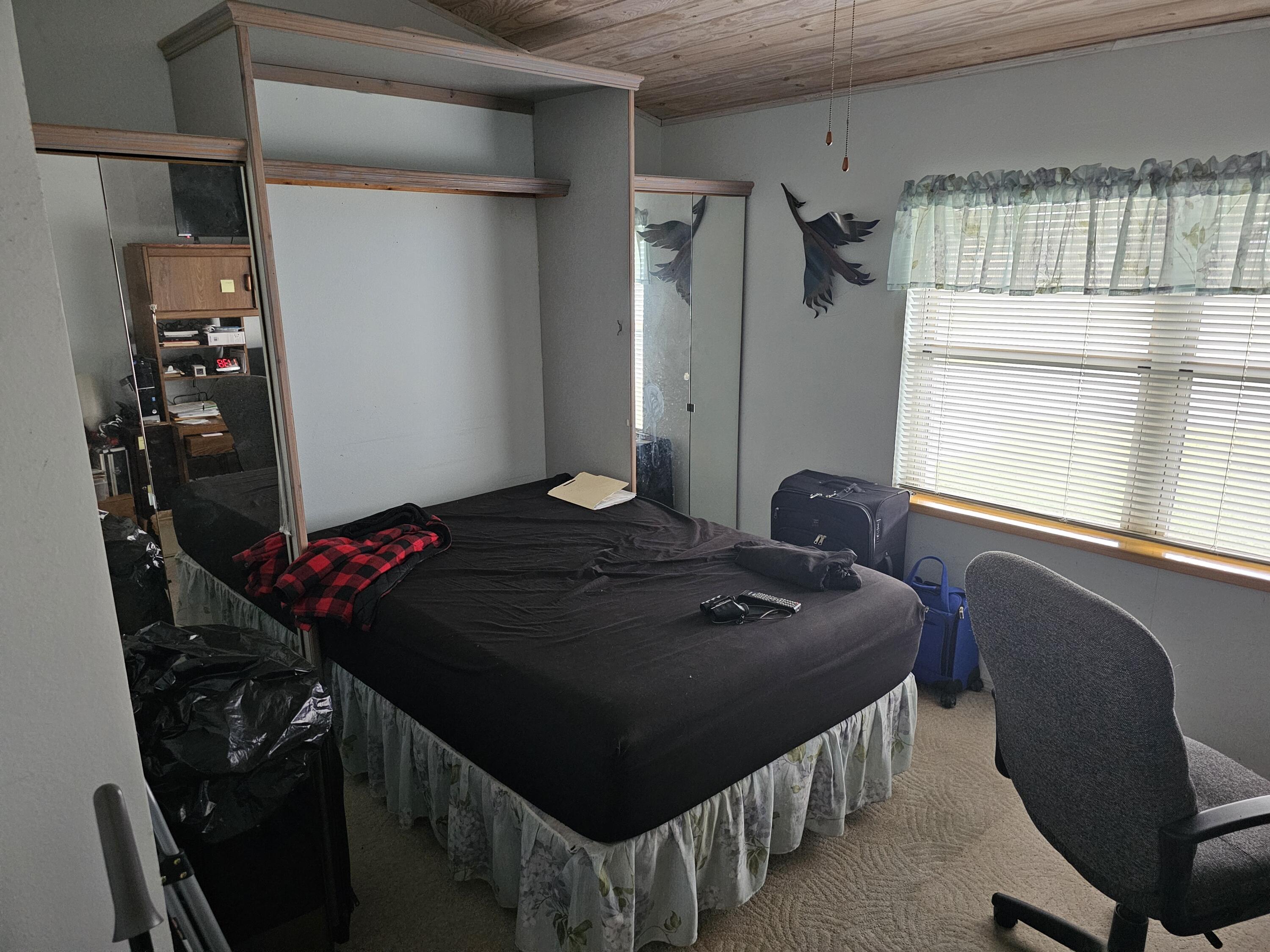 13578 Southwest 144th Parkway Okeechobee, FL 34974 - Photo 18 of 21 a bedroom with a bed closet and a window