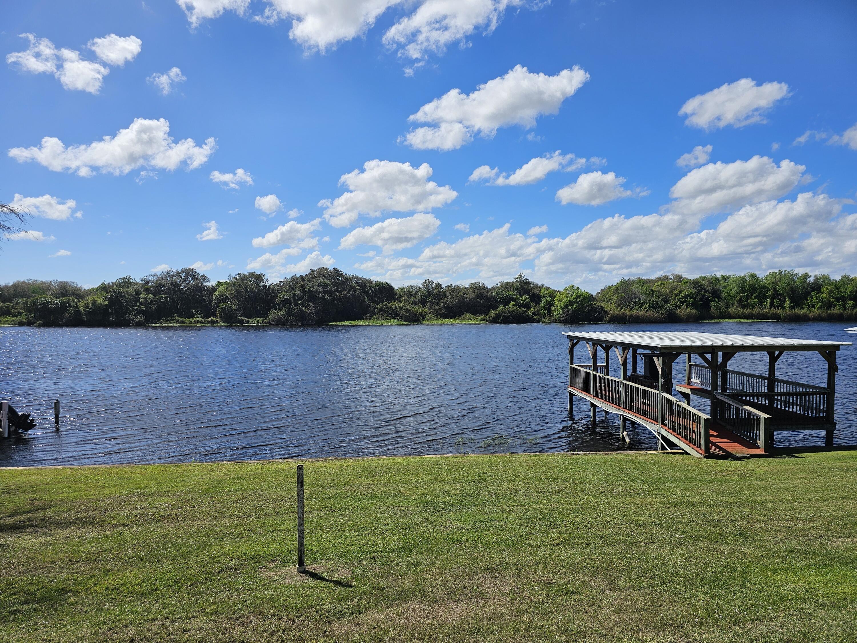 13578 Southwest 144th Parkway Okeechobee, FL 34974 - Photo 6 of 21 a view of a lake with a yard