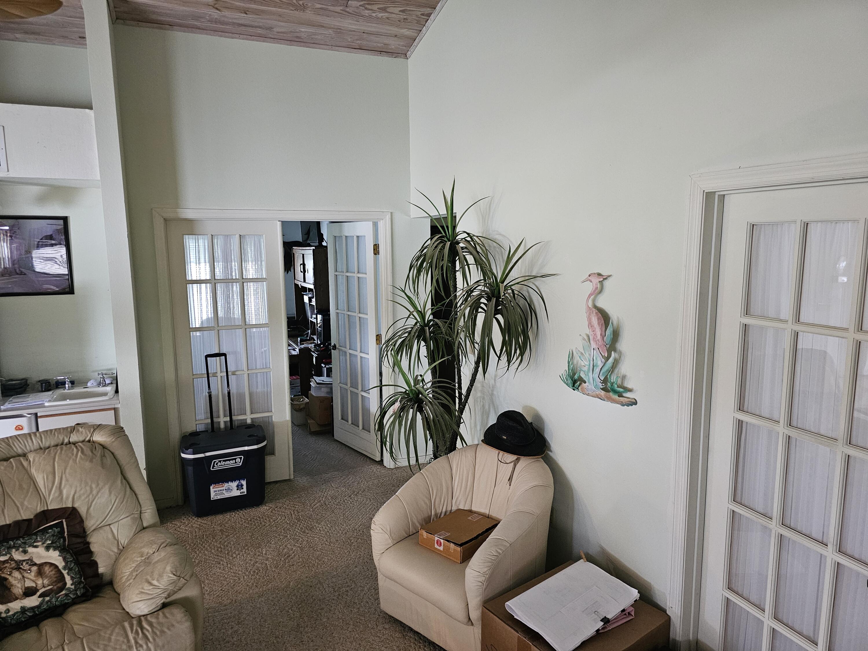 13578 Southwest 144th Parkway Okeechobee, FL 34974 - Photo 10 of 21 a living room with furniture and a potted plant