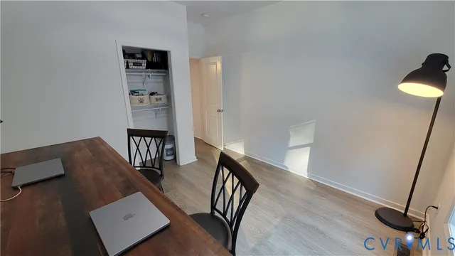 a view of a dining room with furniture and wooden floor
