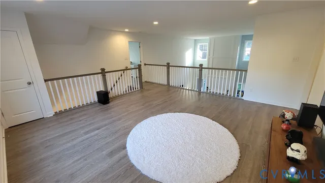 a view of a room with chair and wooden floor
