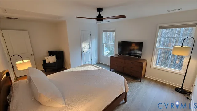 a bedroom with a bed and a television