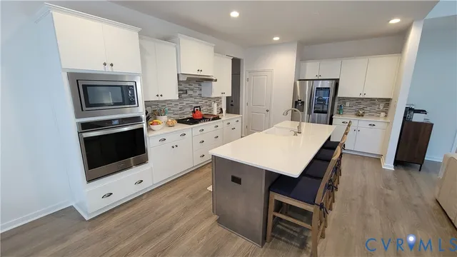 a living room with furniture a flat screen tv and a table