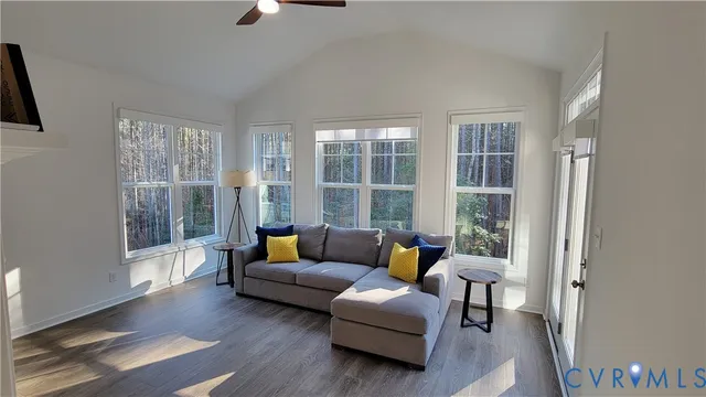 a kitchen that has a microwave a stove and white cabinets