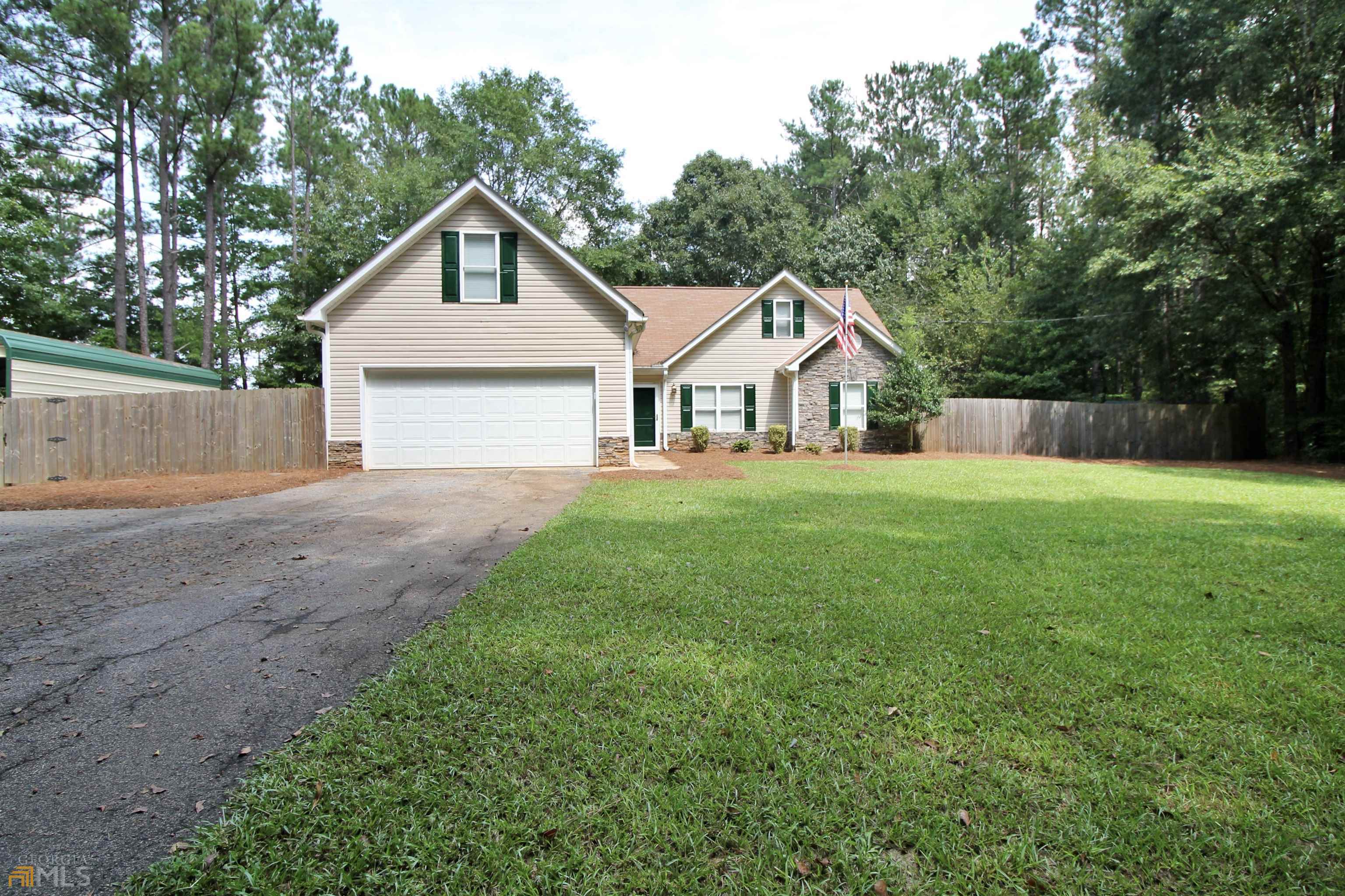 121 Parker Road Covington, GA 30014 - Photo 1 of 1 a front view of a house with yard and green space