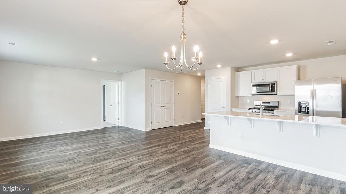 313 Vero Road Egg Harbor Township, NJ 08234 - Photo 4 of 14 a view of a kitchen with kitchen island wooden floor center island and stainless steel appliances