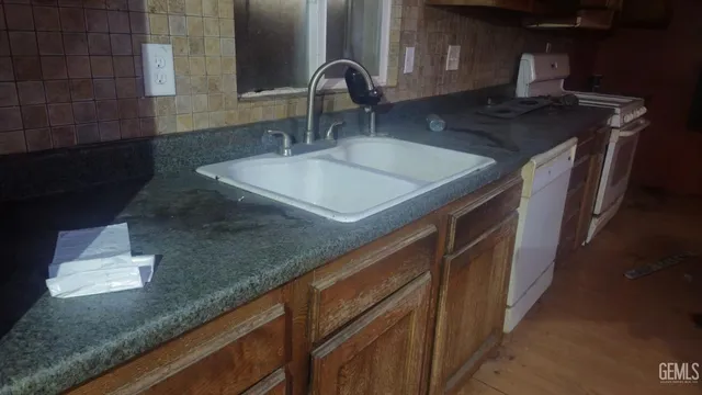 a kitchen with a sink and a stove