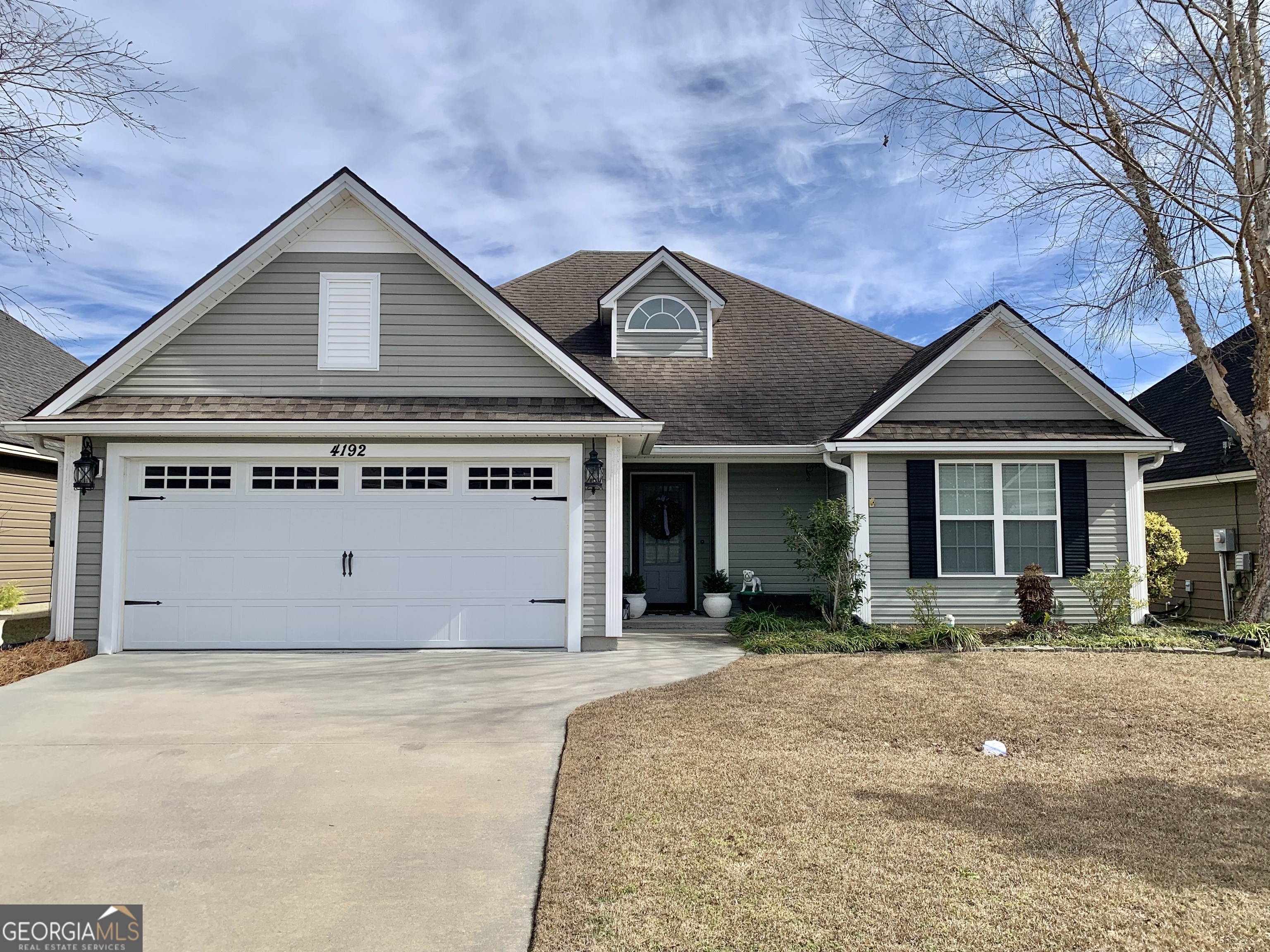 a front view of a house with a yard and garage